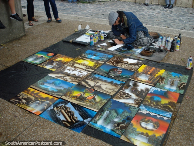 A man paints spraycan landscapes at Plaza Bolivar in Merida. (640x480px). Venezuela, South America.