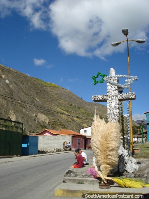 A stone cross and colorful feathers in a town during the El Paramo day trip. (480x640px). Venezuela, South America.
