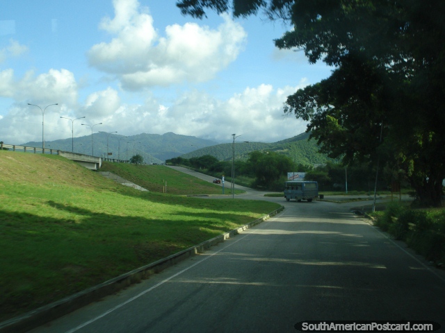 Getting very close to Puerto Cabello, highway off-ramp and green hills. (640x480px). Venezuela, South America.