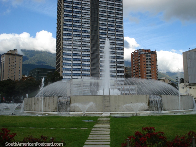 Huge fountain at Plaza Venezuela in Caracas, with red flower gardens. (640x480px). Venezuela, South America.
