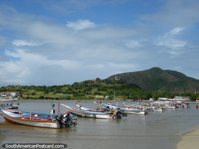 Fishing boats in the water in Juan Griego, Fort Galera on the hill, Isla Margarita. (640x480px). Venezuela, South America.