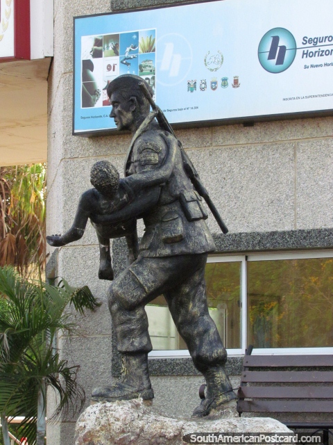 Statue, soldier carries child, outskirts of Maracaibo. (480x640px). Venezuela, South America.