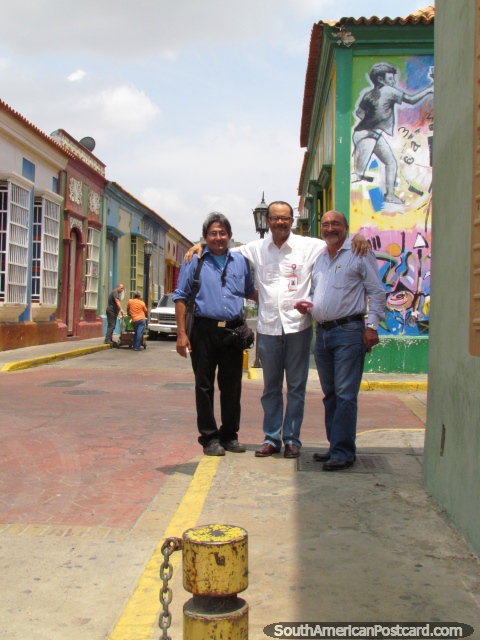 3 businessmen pose for a photo in Carabobo Street in Maracaibo. (480x640px). Venezuela, South America.