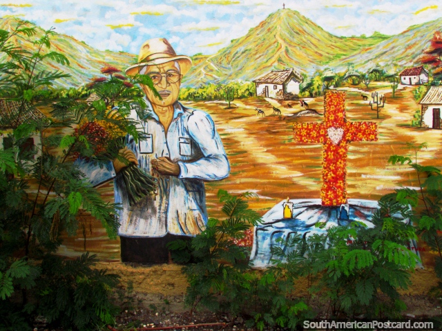 Pintura mural de un hombre y pueblo con cruz roja y amarilla grande, El Tintorero. (640x480px). Venezuela, Sudamerica.