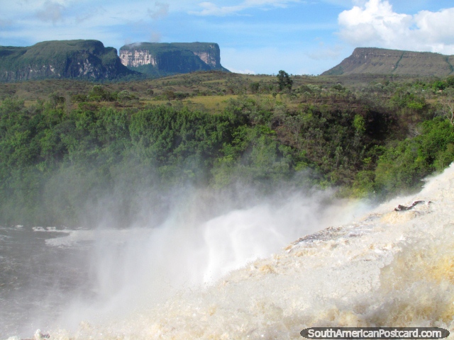 Table top mountains in the distance across waterfall Salto El Sapo in Canaima. (640x480px). Venezuela, South America.