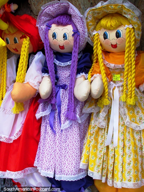 Yellow, purple and red dolls traditionally dressed in German clothing, Colonia Tovar. (480x640px). Venezuela, South America.