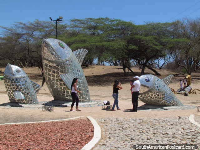 Mirrored fish monuments at a park in Coro, people enjoy. (640x480px). Venezuela, South America.