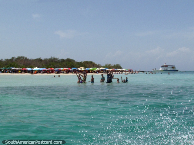 People enjoying themselves at Playa Azul waving to our boat, Morrocoy National Park. (640x480px). Venezuela, South America.