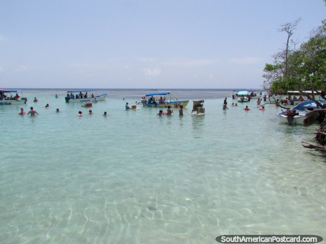 People swim in the shallow waters around Cajo Los Juanes, Morrocoy National Park. (640x480px). Venezuela, South America.